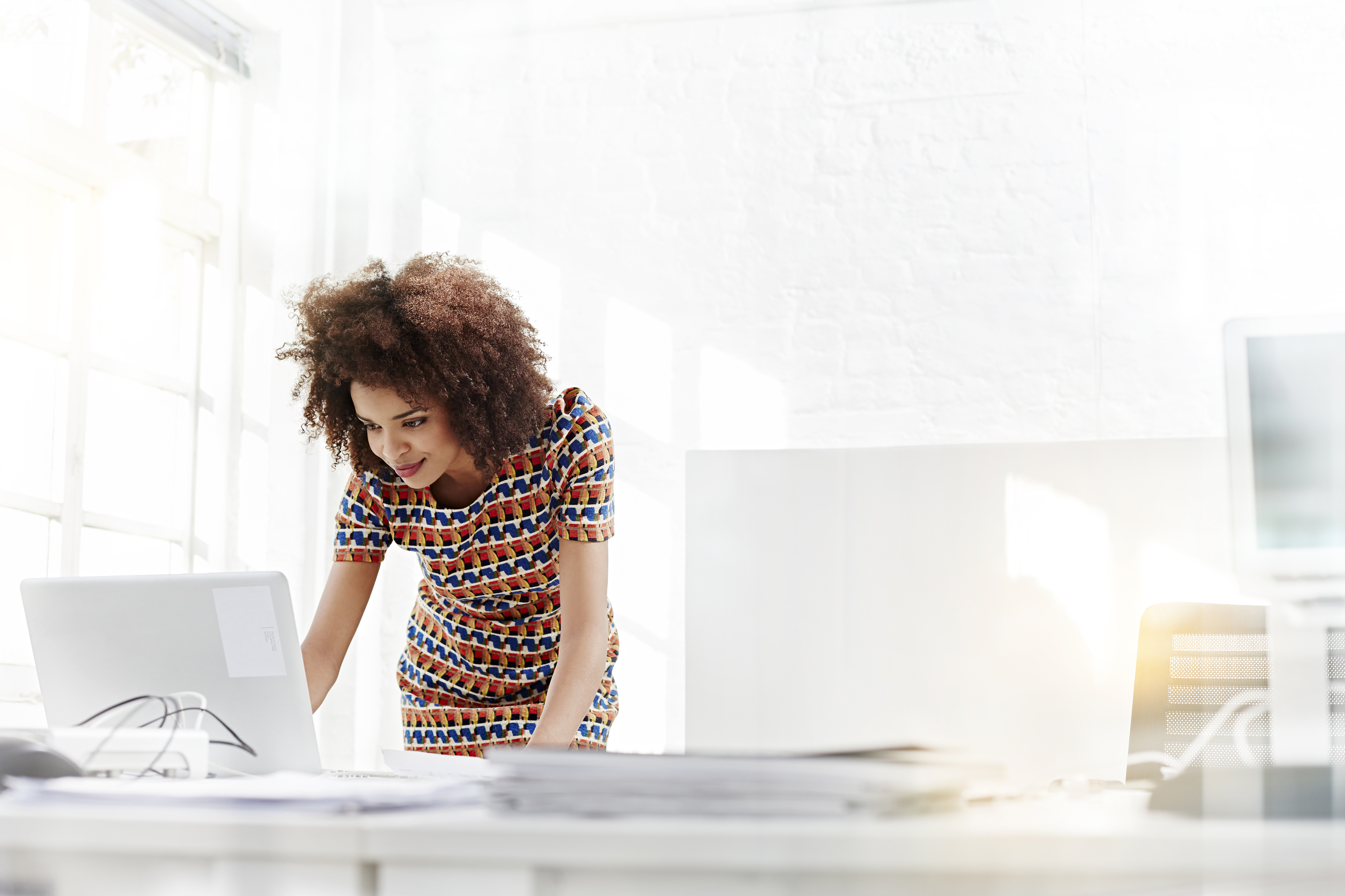 Credit Union professional on laptop accessing Raddon Research and Insights 